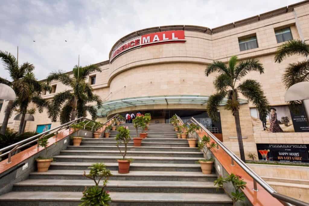 Exterior view of main entrance to Ambience Mall Vasant Kunj, with stairs leading up to the main doors