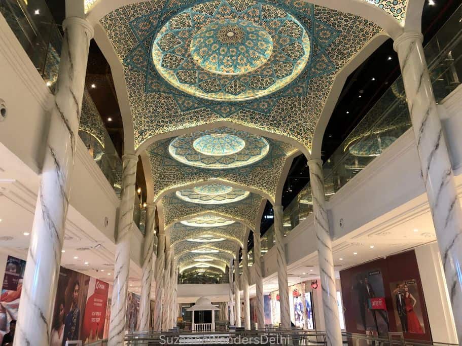 interior of Omaxe Chowk mall in Delhi with ornate painted and carved ceiling