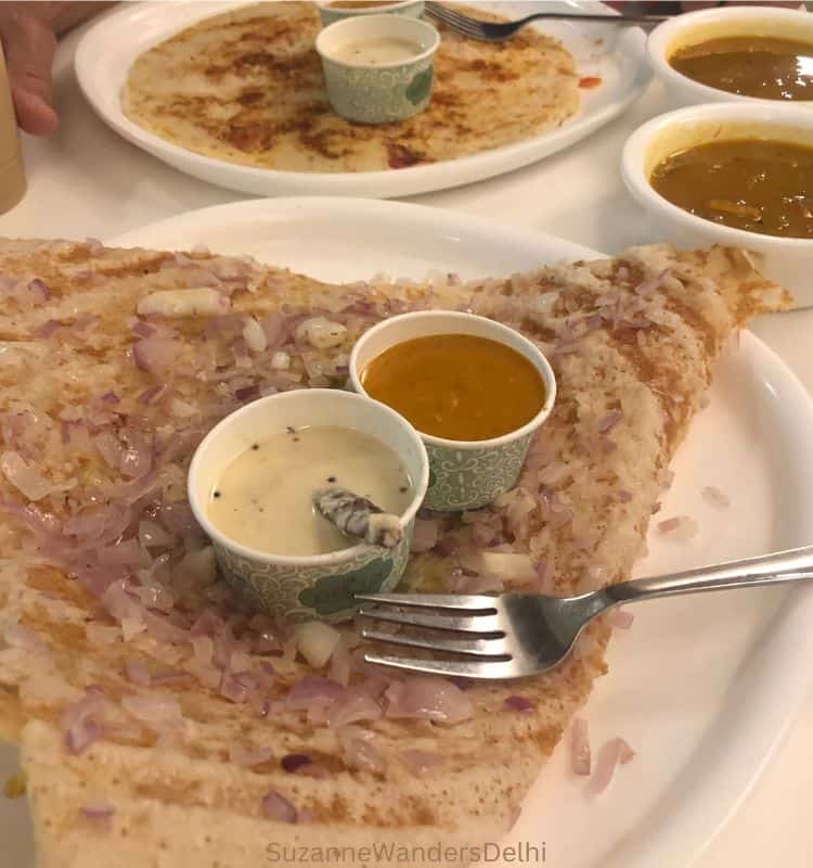 two white plates with dosa and uttapam at Evergreen Sweet House, a famous Delhi restaurant