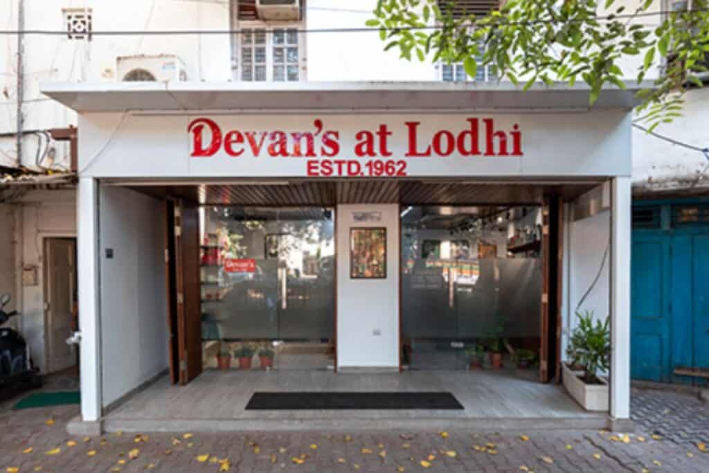 Exterior view of Devan's with white signage and door - Devan's is the original of the best coffee shops in Delhi
