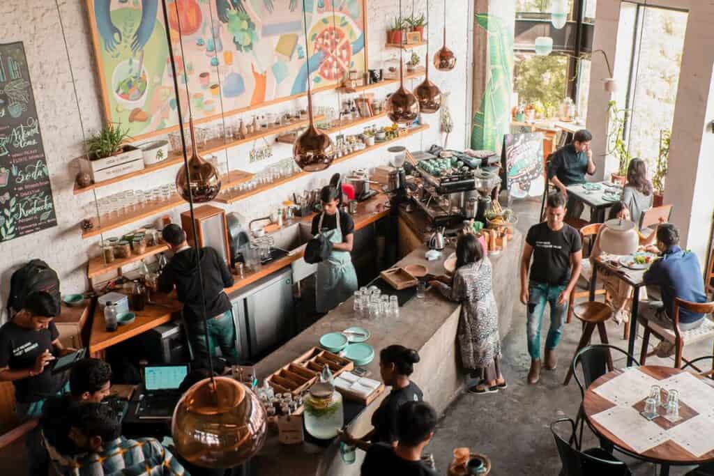 overhead view of the interior of Greenr Cafe in Gurugram with large colourful painting and diners