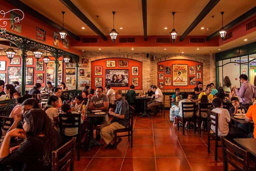 interior of the Big Chill Cafe showing busy restaurant full of diners all sitting at tables with brick coloured floor tiles and red and brown themed walls