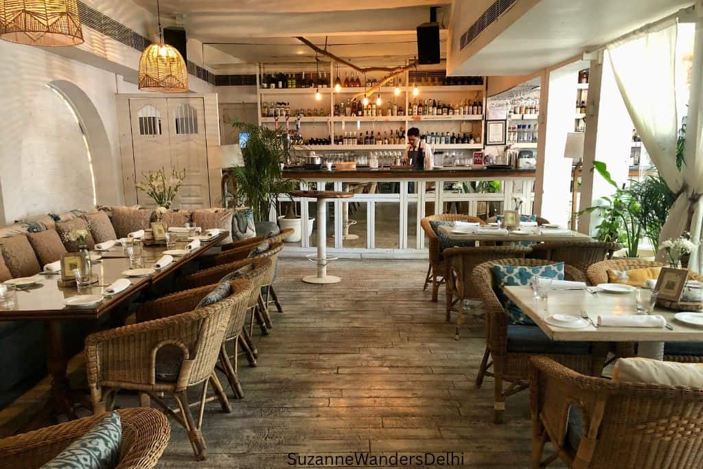 interior of Olive Bar and Kitchen with wicker chairs, tables and bar in back