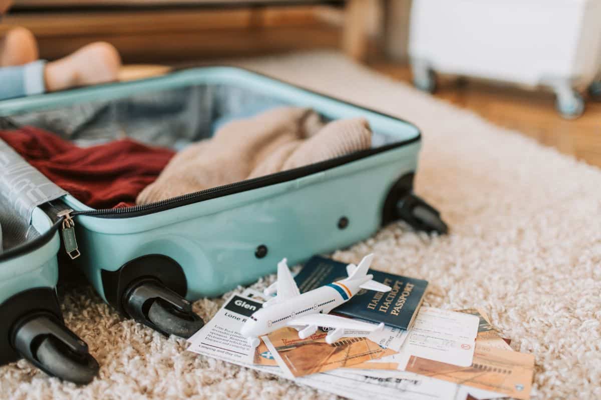 an open blue suitcase on beige shag carpet