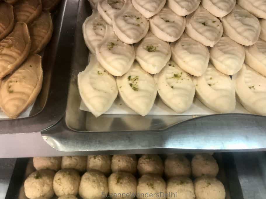 3 varieties of sondesh in a display case at Kamala Sweets in Delhi