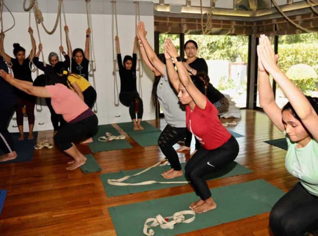 yoga students in class doing chair pose at the Iyengar Yoga Centre Yogakshema in Delhi