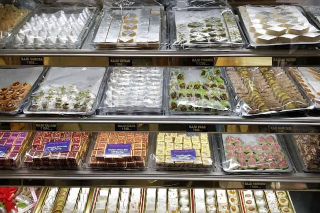Glass display case of assorted mithai in Bangla Sweet House, one of the best mithai shops in Delhi