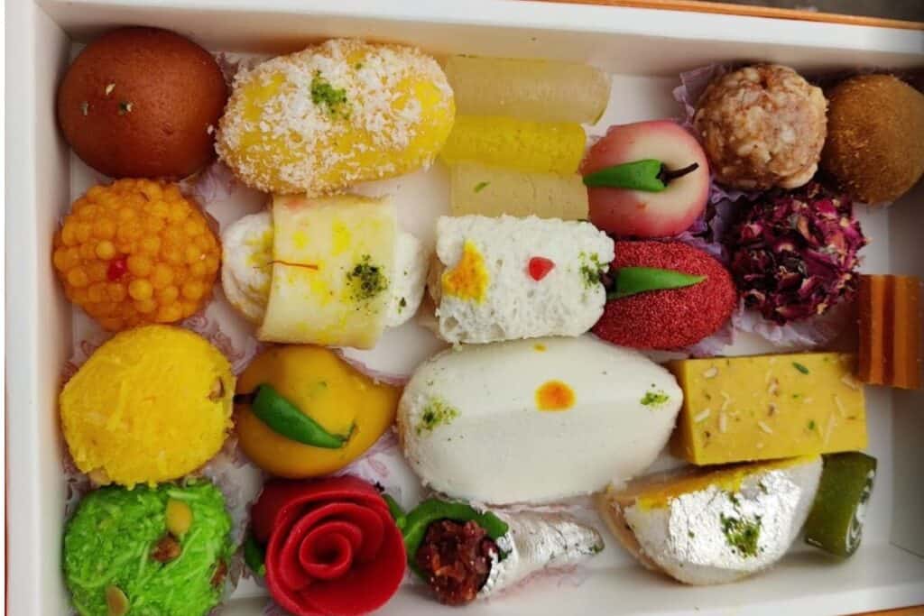 box of assorted and beautiful mithai in different colours and shapes, at Shagun Sweets in Delhi