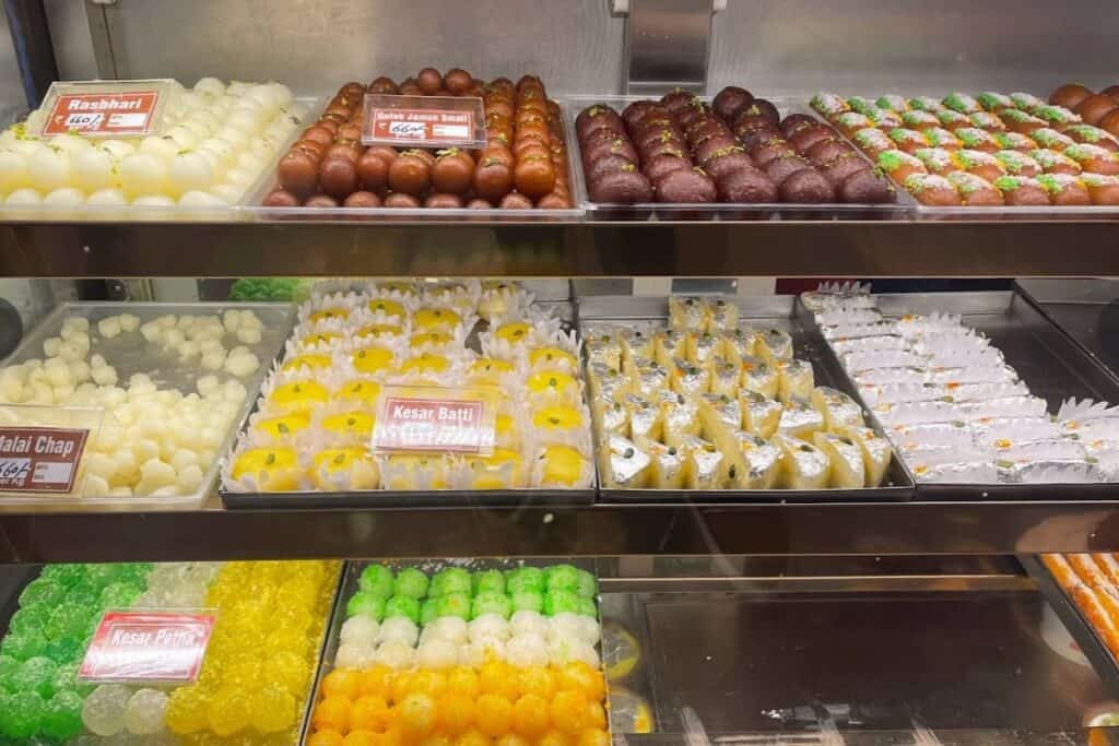 glass display case with colourful mithai at Bansal Sweets in Delhi, one of the best sweet shops