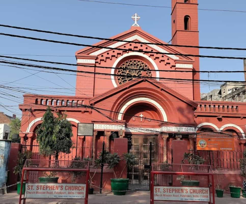 exterior view of red church with bell tower, St Stephen's Church in Delhi