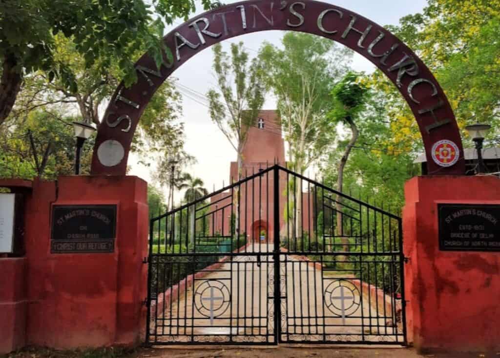 entrance gate with red arch with view of St. Martin's Church in back, one of the famous churches in Delhi