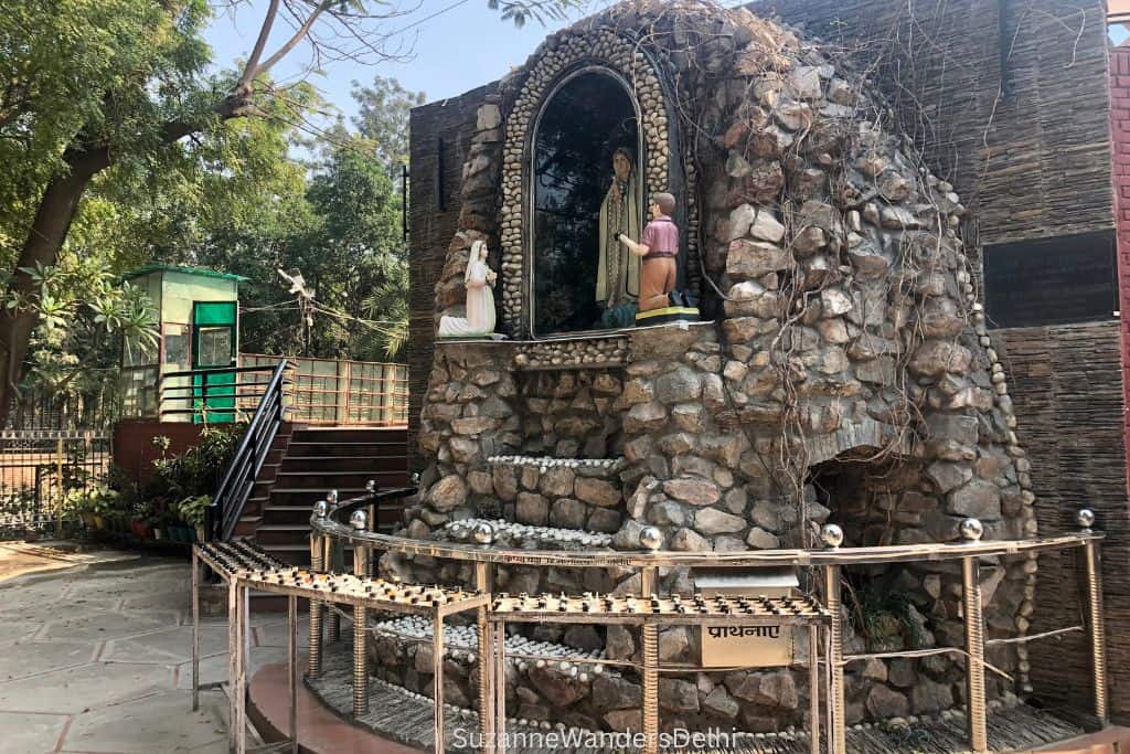 stone enclosed statue of the Virgin Mary in front of Church of St. Theresa of Child Jesus