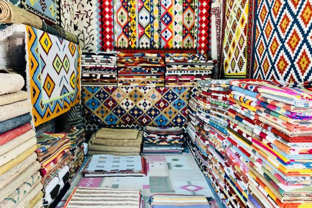 A colourful display of Indian rugs in traditional designs at Dilli Haat INA