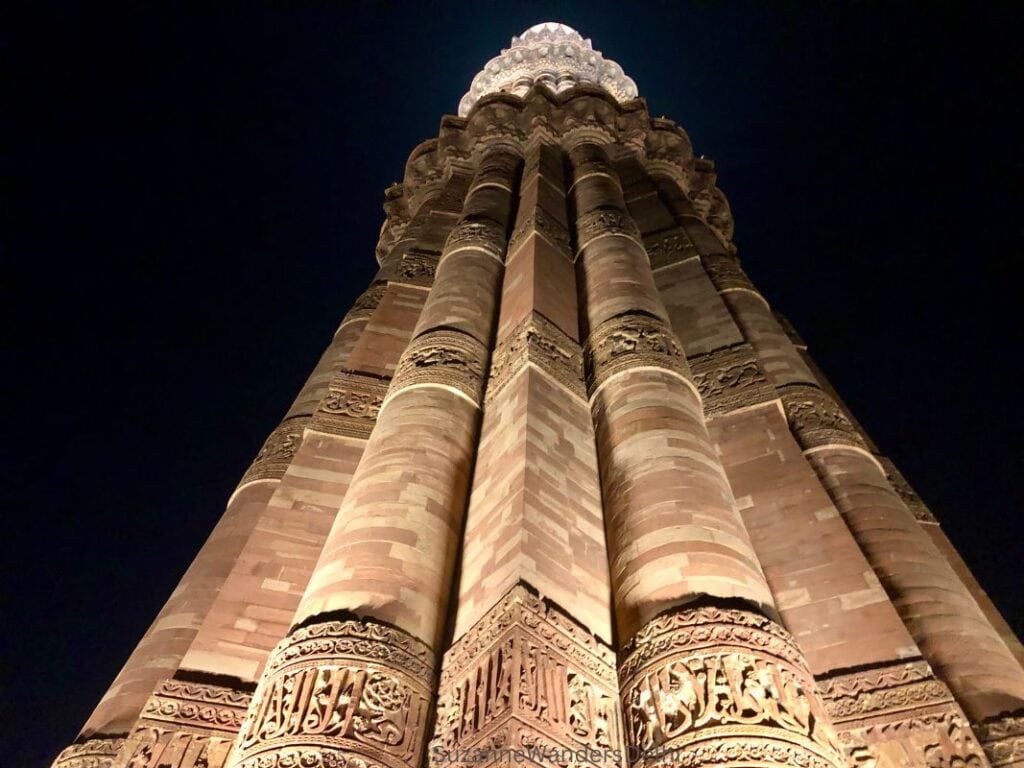 a view looking up at the Qutub Minar in Delhi at night