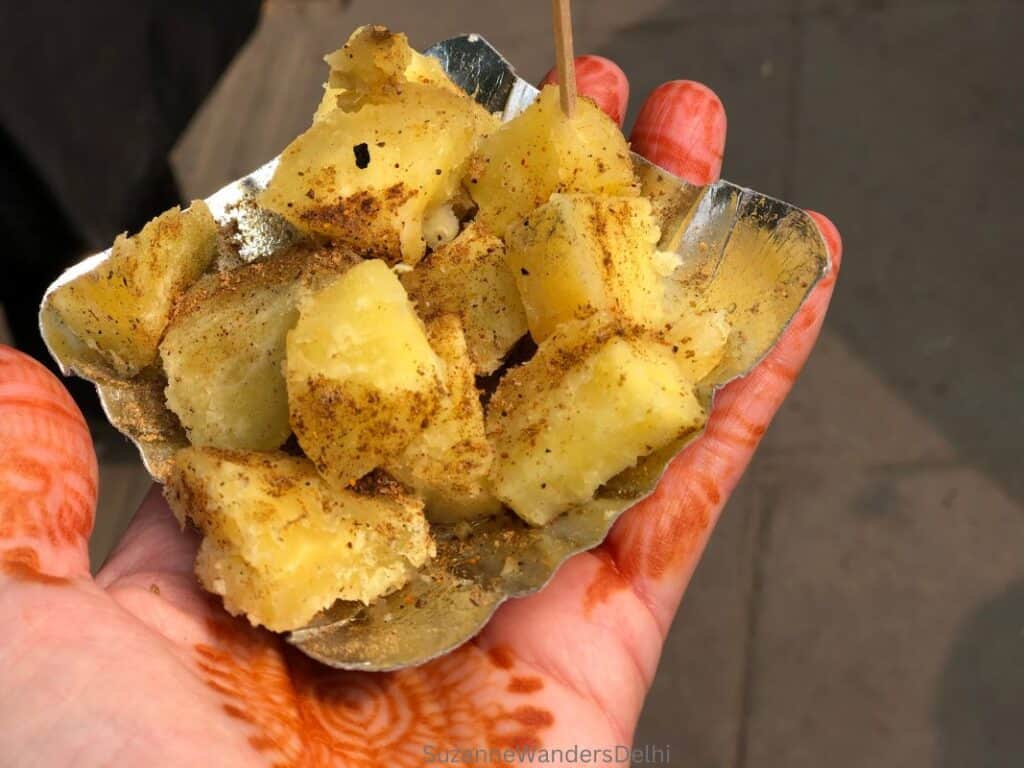 a small silver paper dish of shakarkandi ki chaat, the special winter food of Delhi