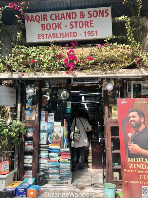 entrance of Faqir Chand with red and white sign and books piled high