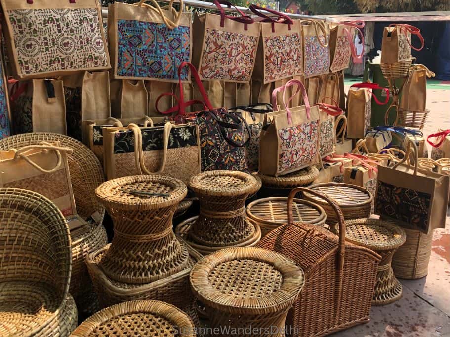 wicker stools and bags set up on floor at Dilli Haat in Delhi