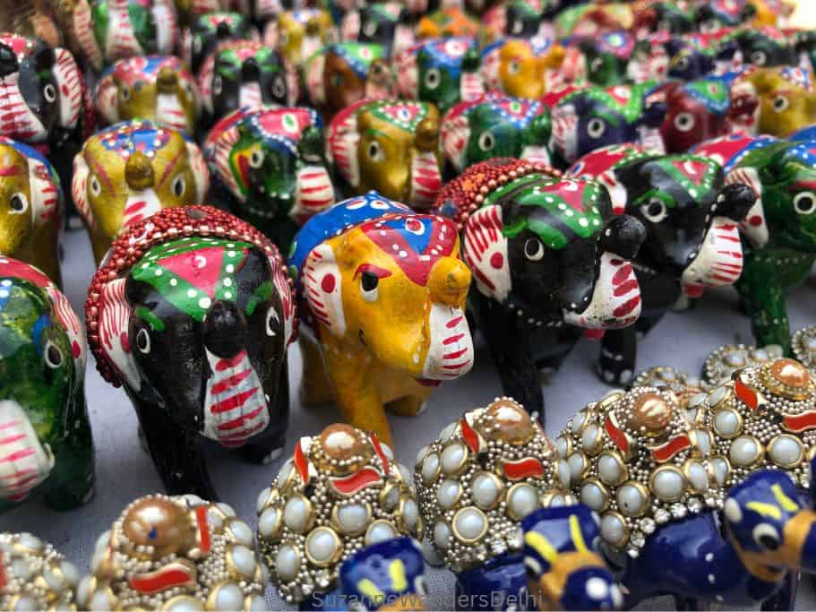 rows of small colourful elephants with beads 