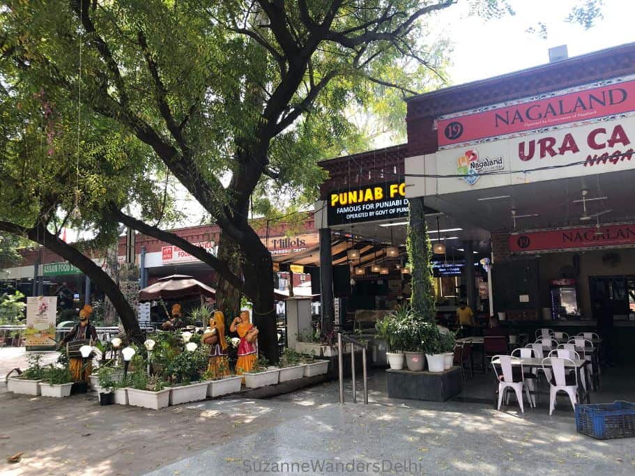 food stands with large tree at Dilli Haat in Delhi