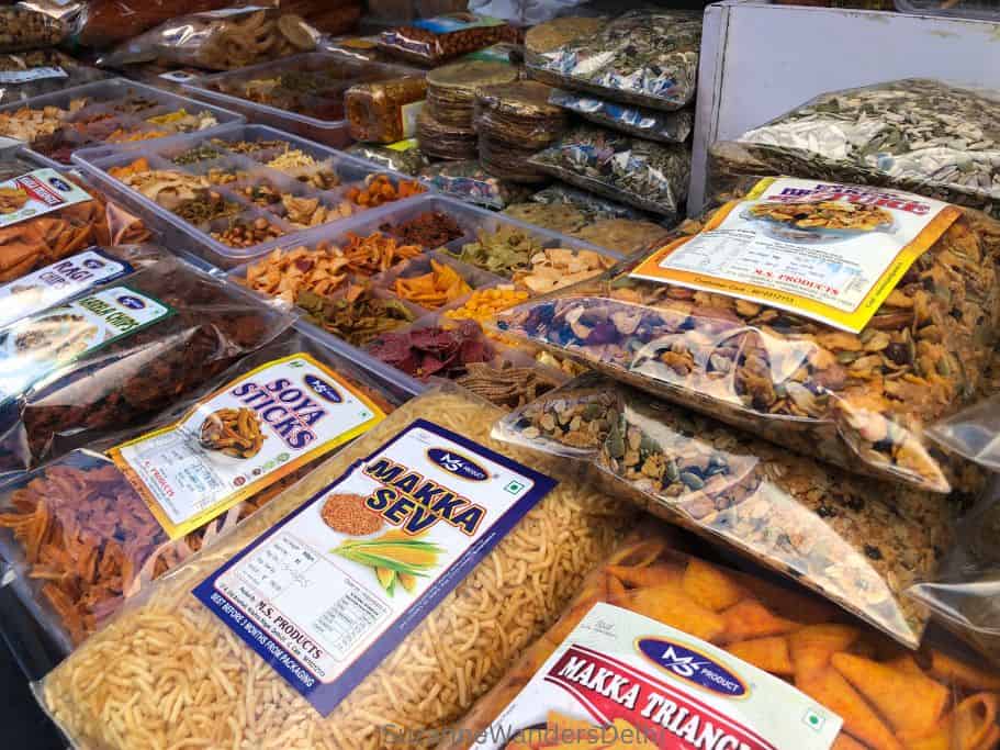 stacks of bags of Indian snacks and granola at Dilli Haat INA