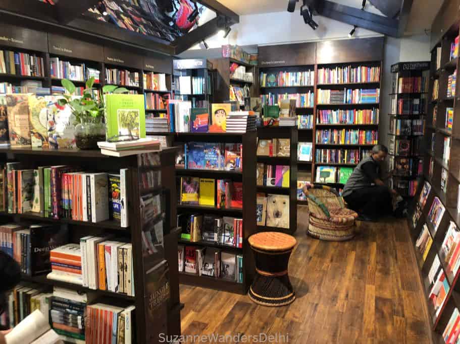 inside The Bookshop with floor to ceiling dark wood book shelves full of books