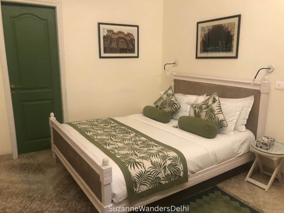 guest room at Colonel's Retreat with queen size bed and green bedding