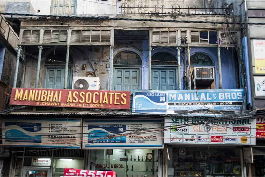 store fronts and dilapidated buildings in Old Delhi