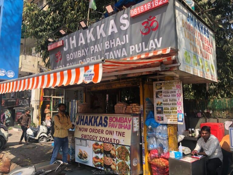 full view of Jhakkas Bombay Pav Bhaji food stand with one customer ordering