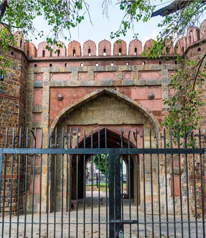 close up of Delhi Gate with wrought iron fence in front of it