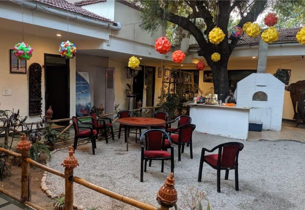 courtyard of the Ethiopian Cultural Centre in Delhi with red and yellow lamps hanging from trees