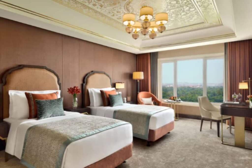 Twin beds iin elaborate hotel room at Taj Mahal New Delhi, one of the best luxury hotels where you can stay with kids in Delhi