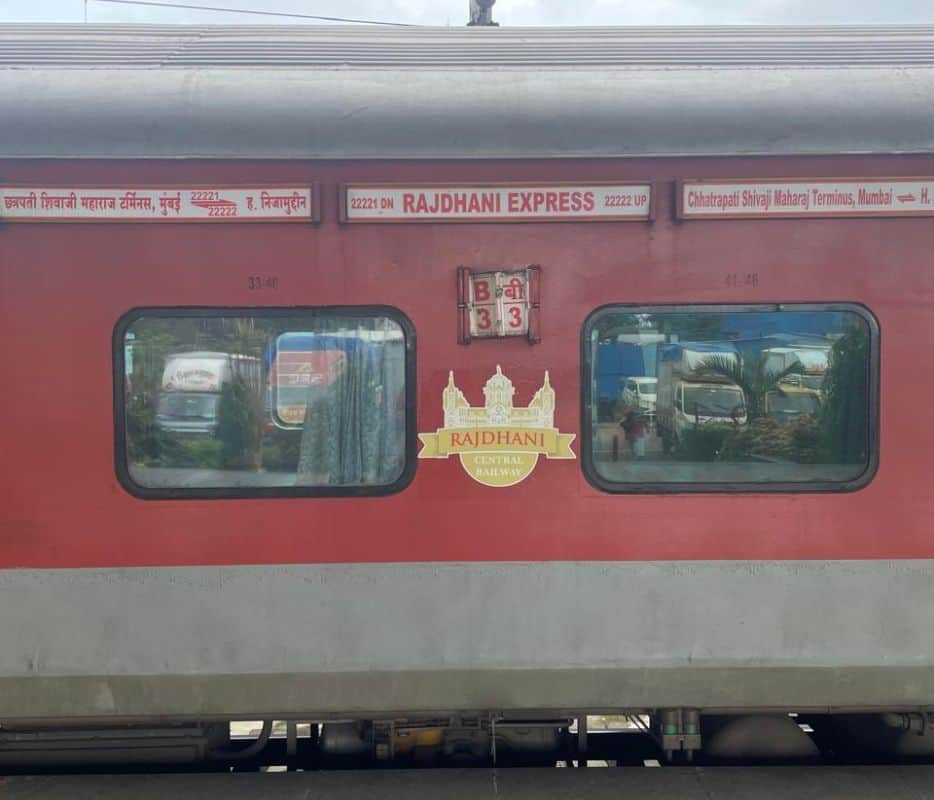 close up of Rajdhani Express train with gold emblem showing Central Railway