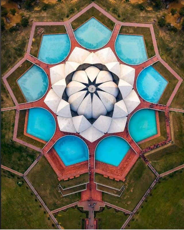 Arial view from above of the Lotus Temple showing 9 blue pools of water and surrounding gardens