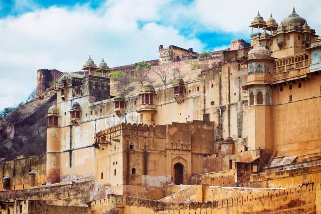 exterior wide view of Amer Palace with its many fort walls and parapets, one of the magnificent sites of the Golden Triangle India