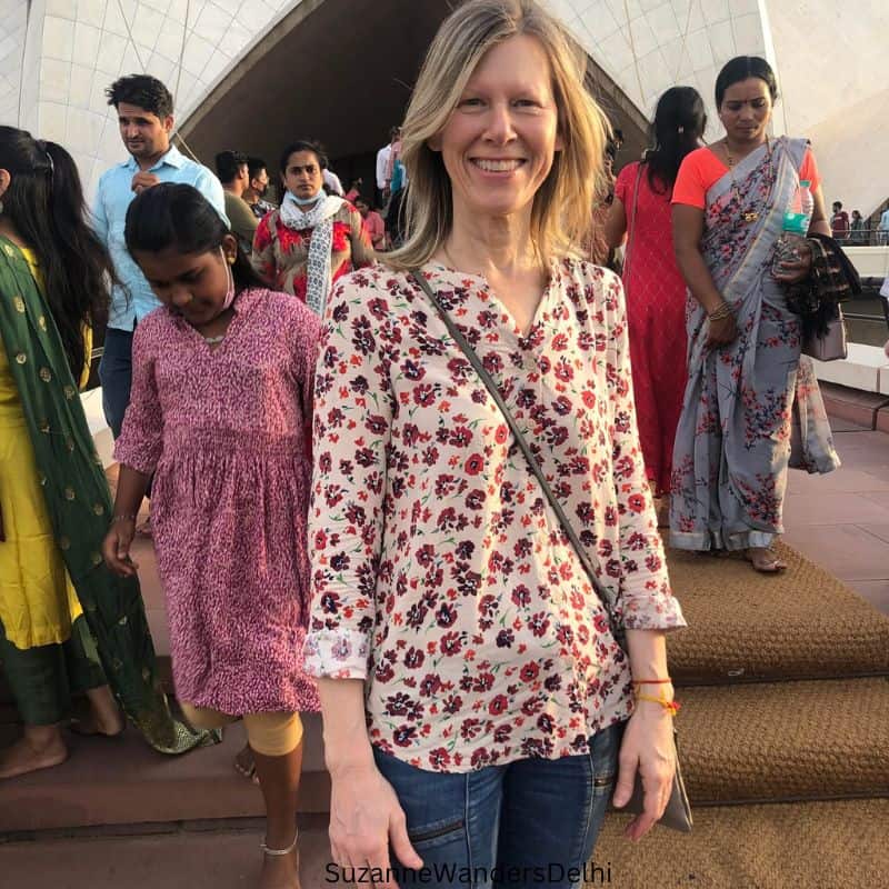 the author standing outside the Bahai Lotus Temple in Delhi with people behind her