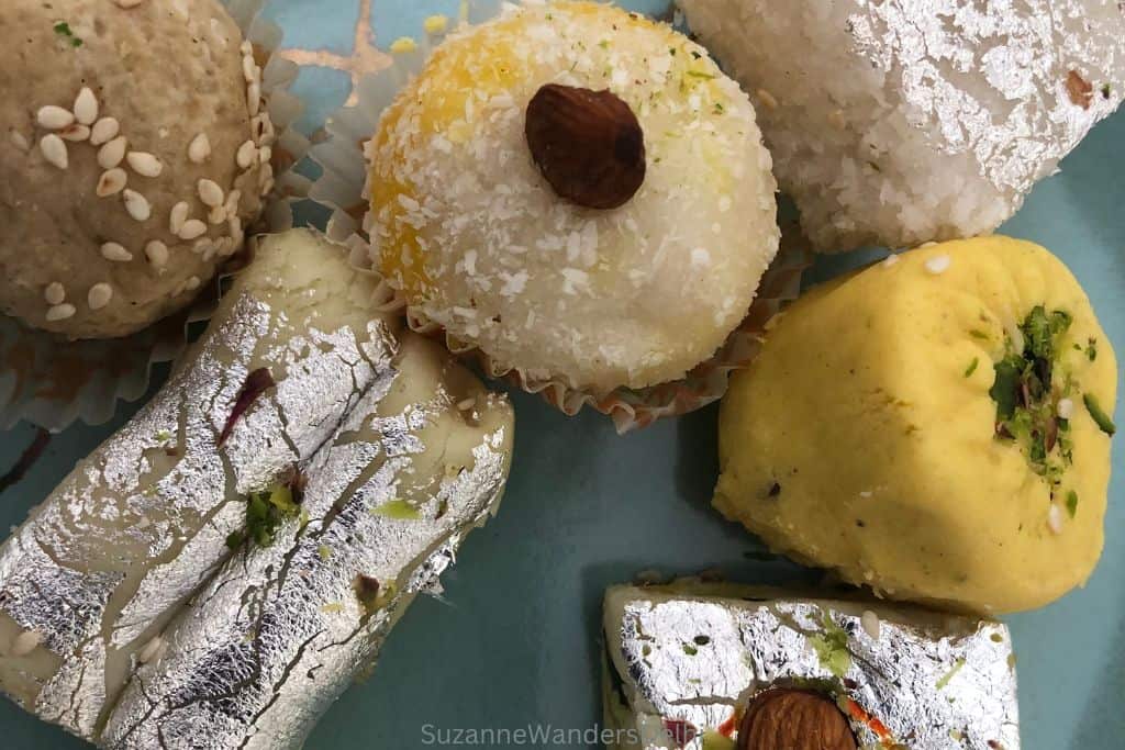 close up of assorted Delhi mithai ona blue plate