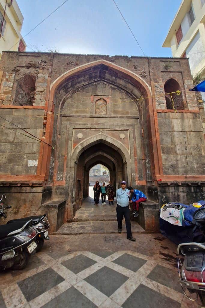 long view of entrance gate to Chausath Khamba courtyard in Nizamuddin Basti