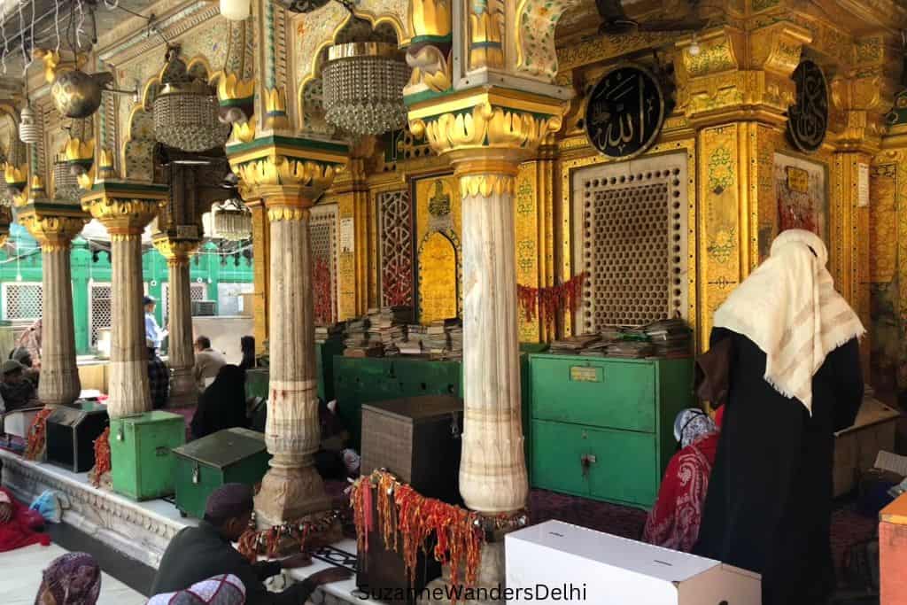 close up of the dargah with columns and gold paint in Nizamuddin Basti