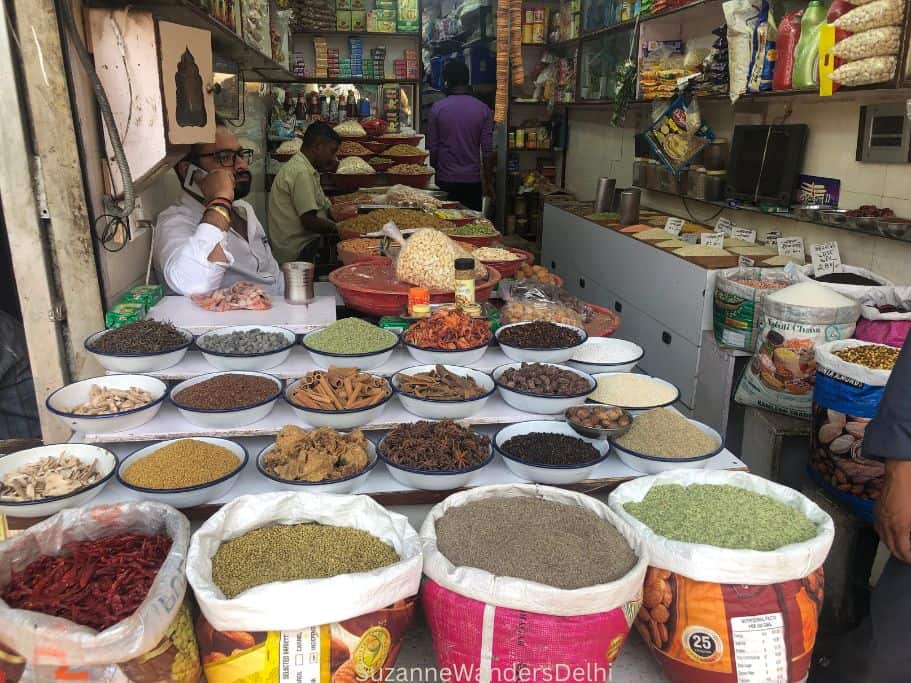 sacks and bowls of whole spices at a Khari Baoli shop in Old Delhi
