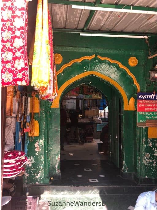 arched green entrance way to visit Hazrat Nizamuddin Dargah in Delhi