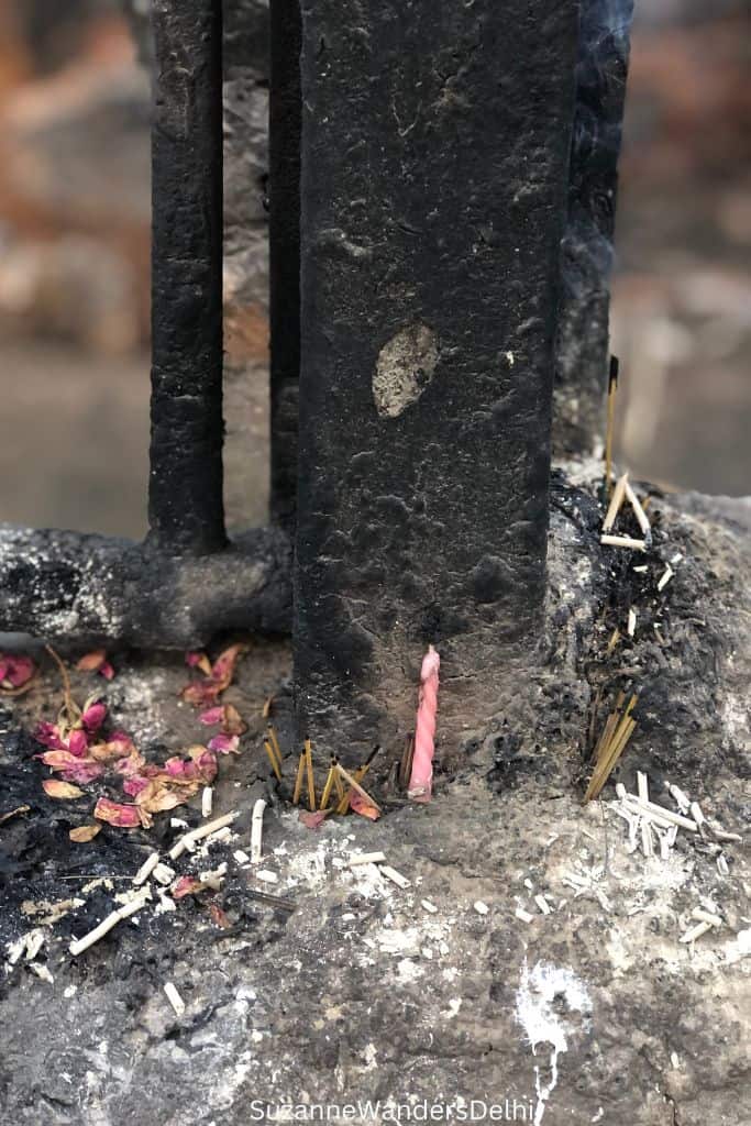 pink candle and petals as offering to djinns at Feroz Shah Kotla Fort in Delhi