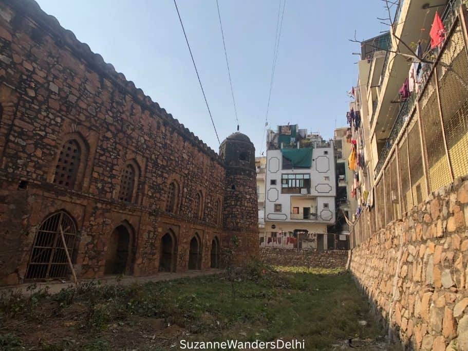 side wall of Khirki Masjid with homes around it in Delhi